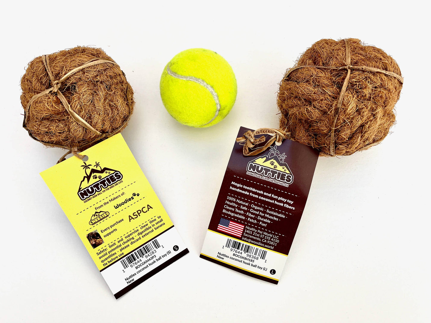 Two coir balls and a tennis ball with  tags on a white background